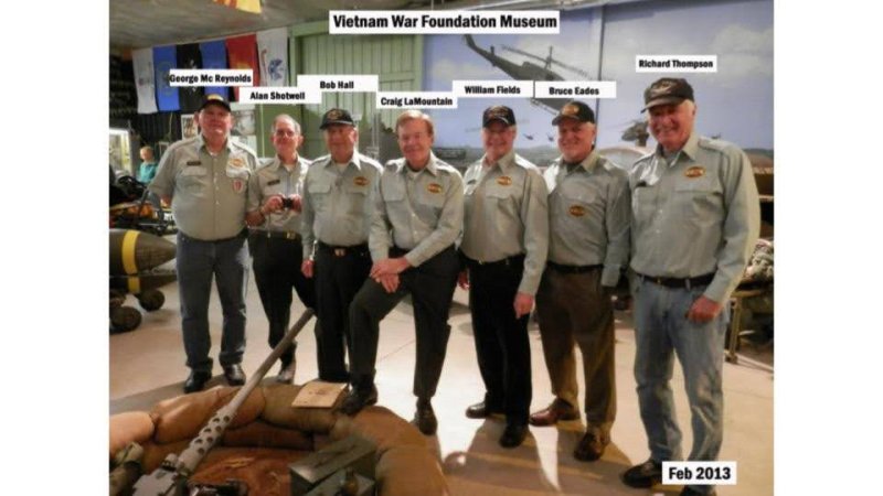 a group of seven older veterans in uniforms